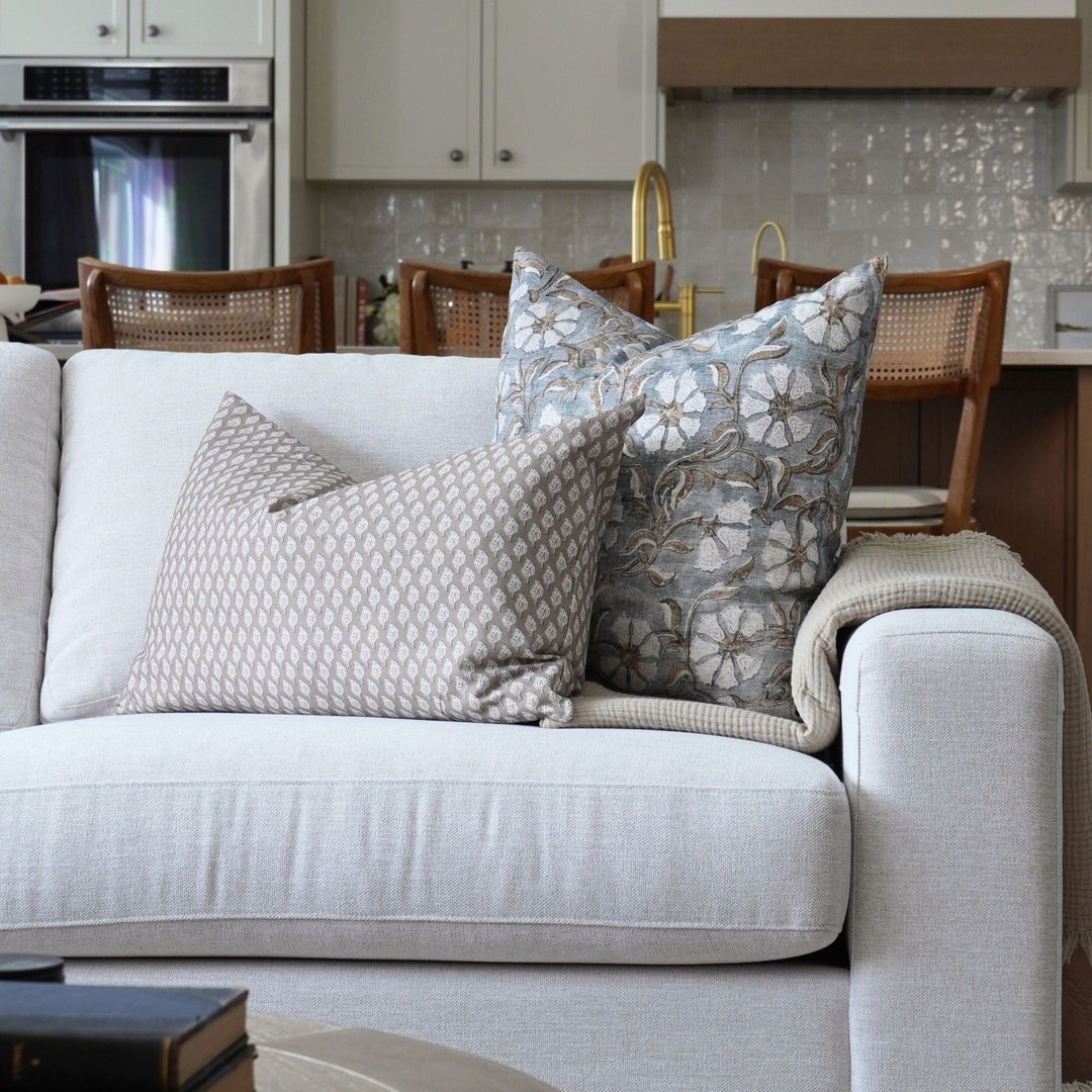 Gray sofa with decorative pillows in a living room setting