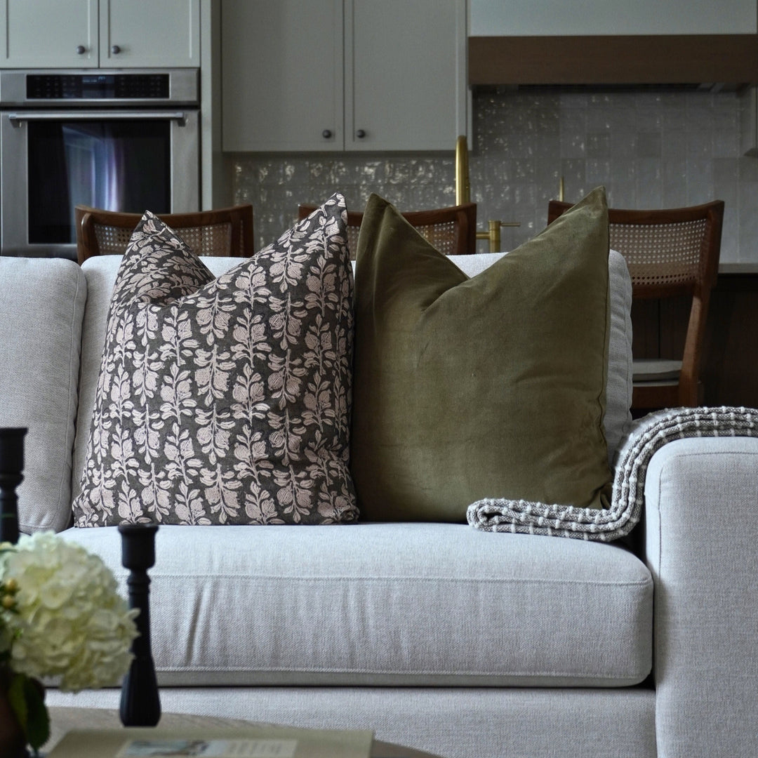 Gray sofa with decorative pillows in a living room setting