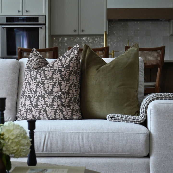 Gray sofa with decorative pillows in a living room setting