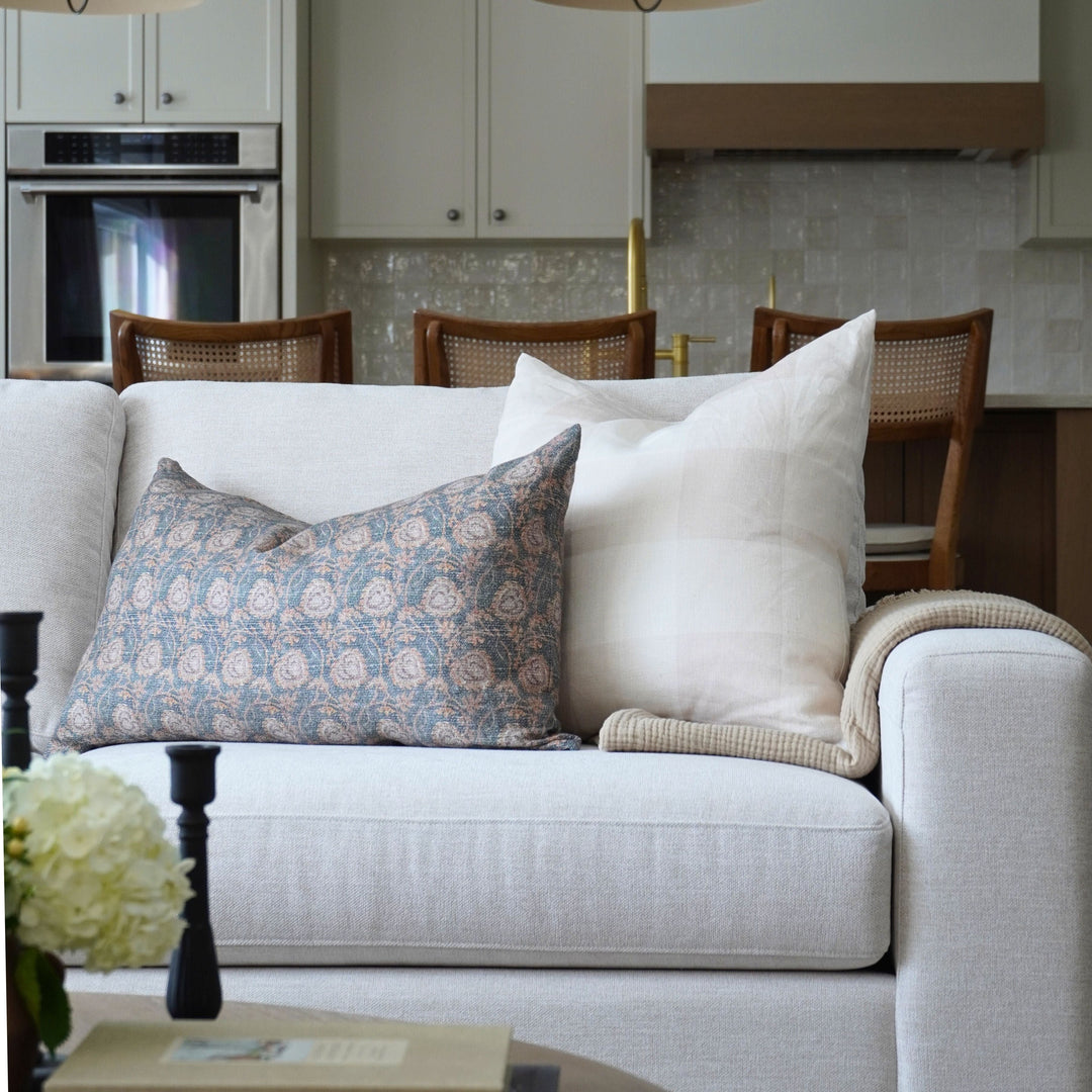 White sofa with decorative pillows in a kitchen setting