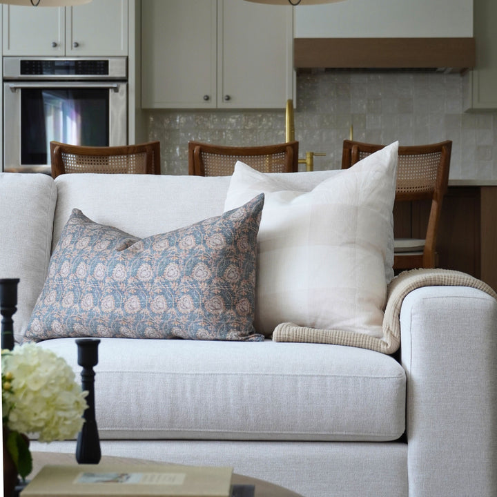 White sofa with decorative pillows in a kitchen setting