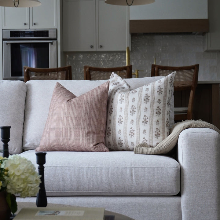 Gray sofa with patterned cushions in a living room setting