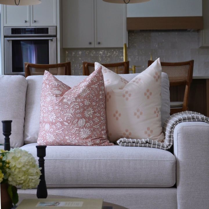 Gray sofa with floral-patterned cushions in a living room setting.