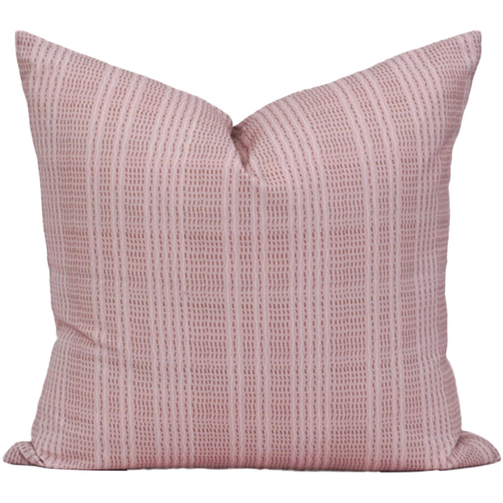 Pink textured pillow on a white background