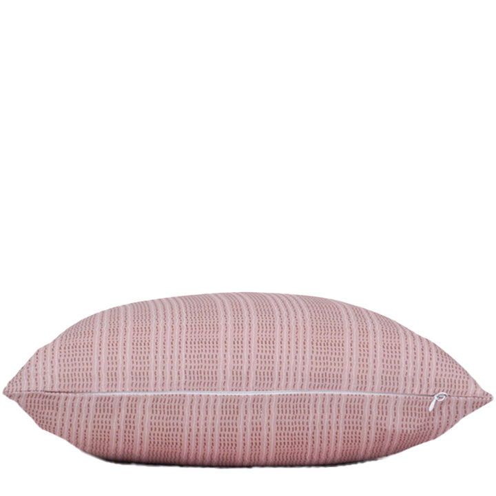 Pink textured pillow on a white background