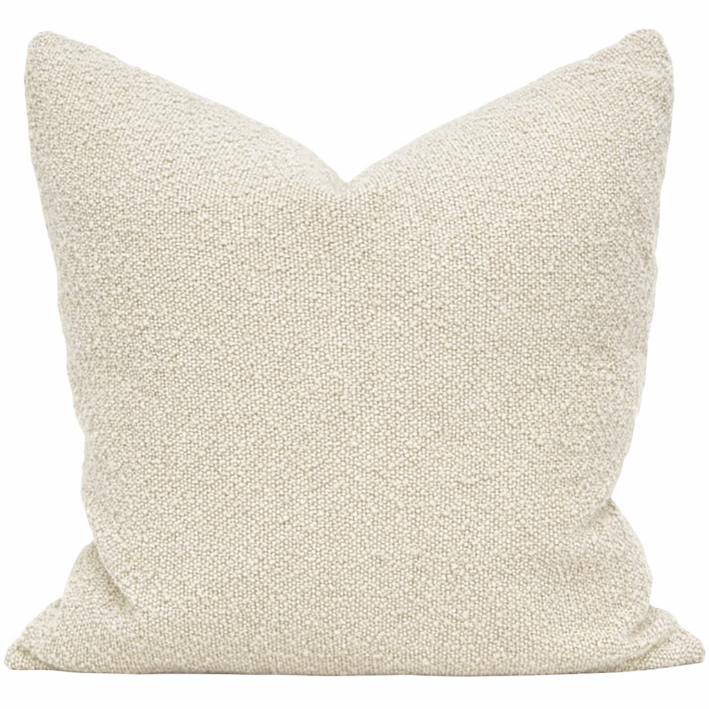Textured beige pillow on a white background