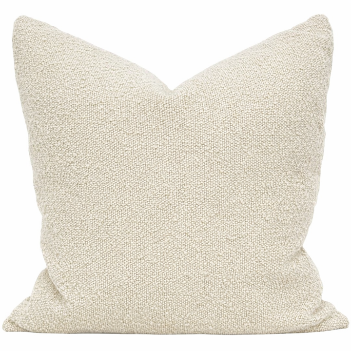 Textured beige pillow on a white background