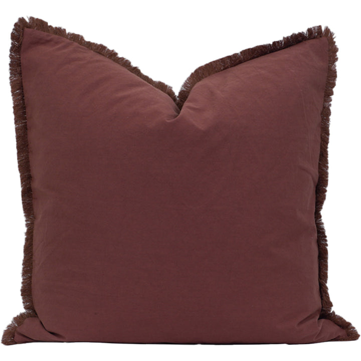 Paprika pillow with frayed edges on a white background