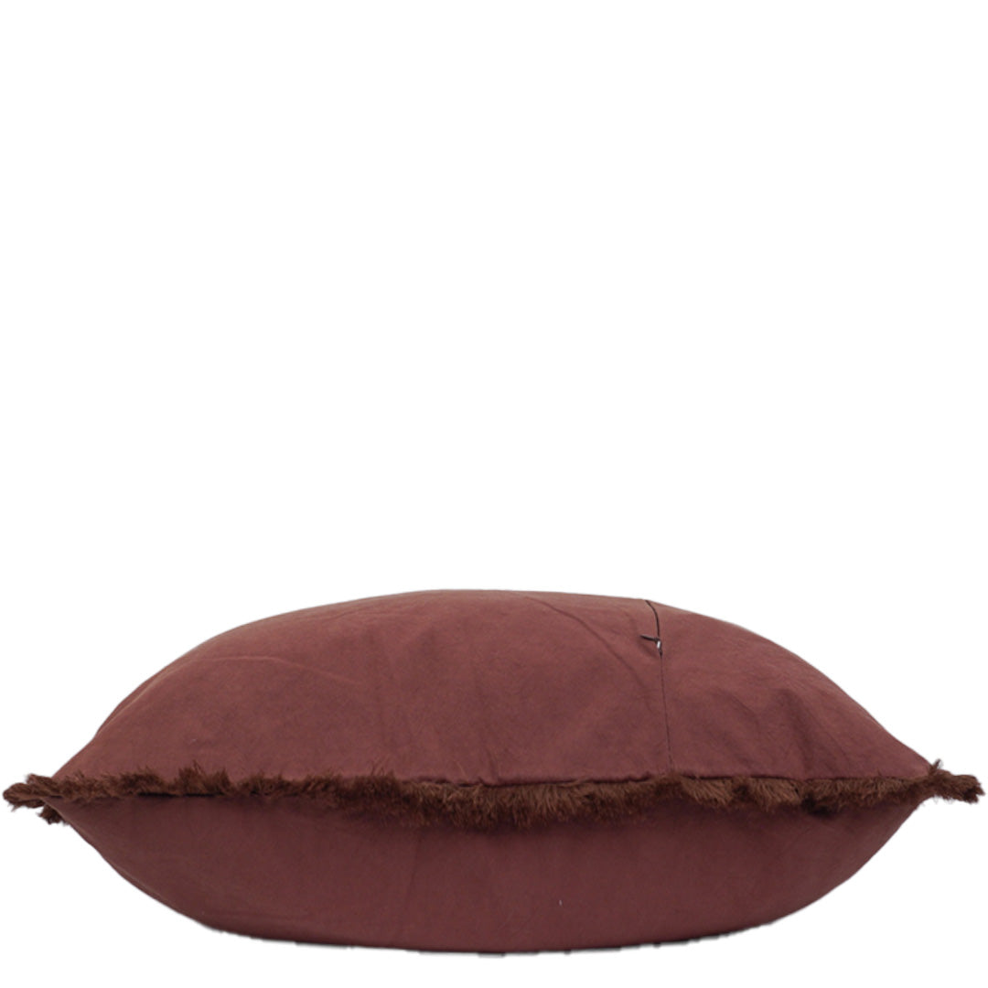 Paprika pillow with frayed edge on a white background