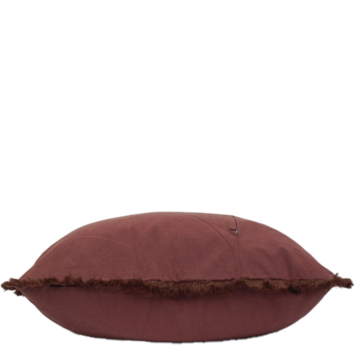 Paprika pillow with frayed edge on a white background