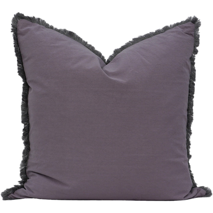 Grey pillow with black fringe on a white background