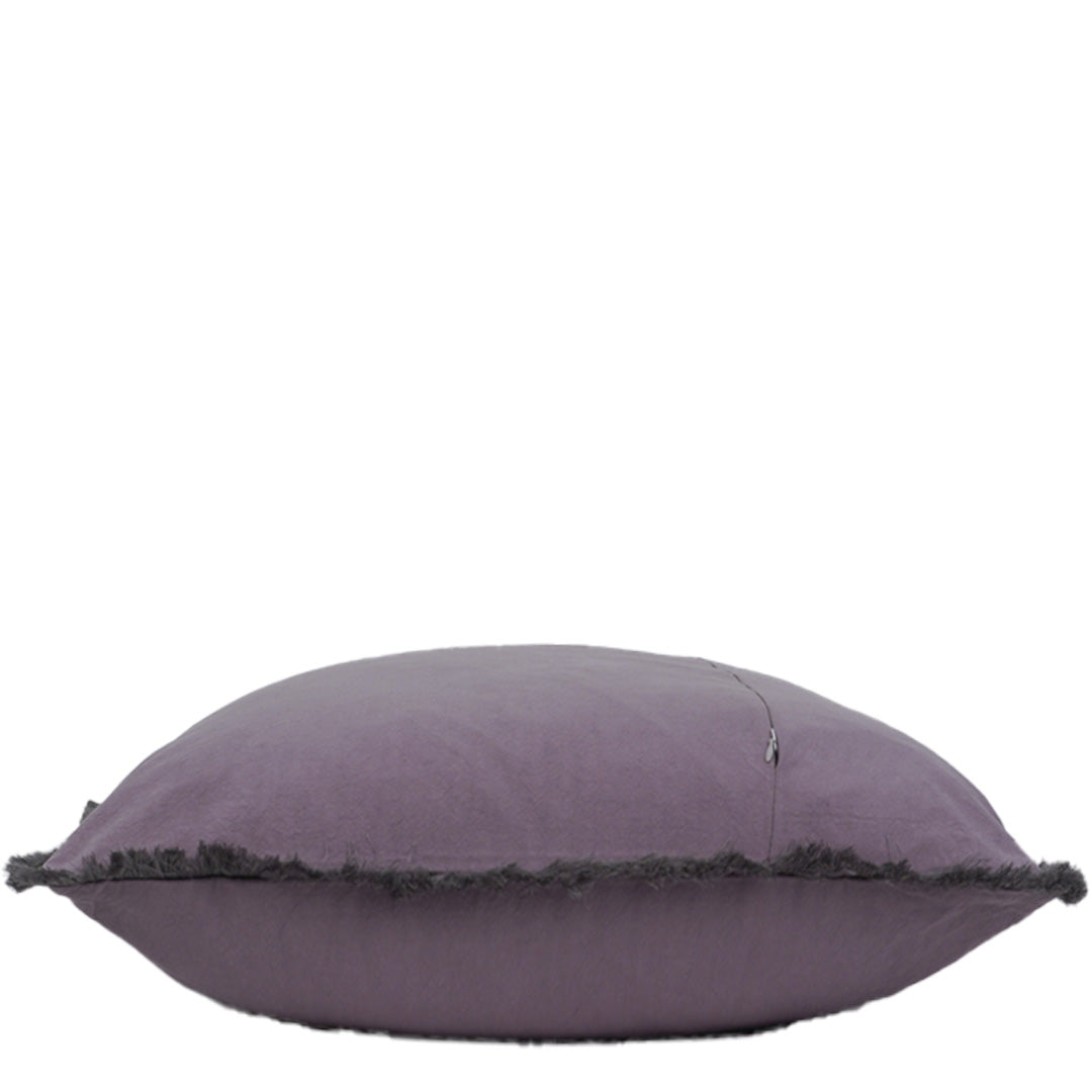 Grey pillow with frayed edge on a white background