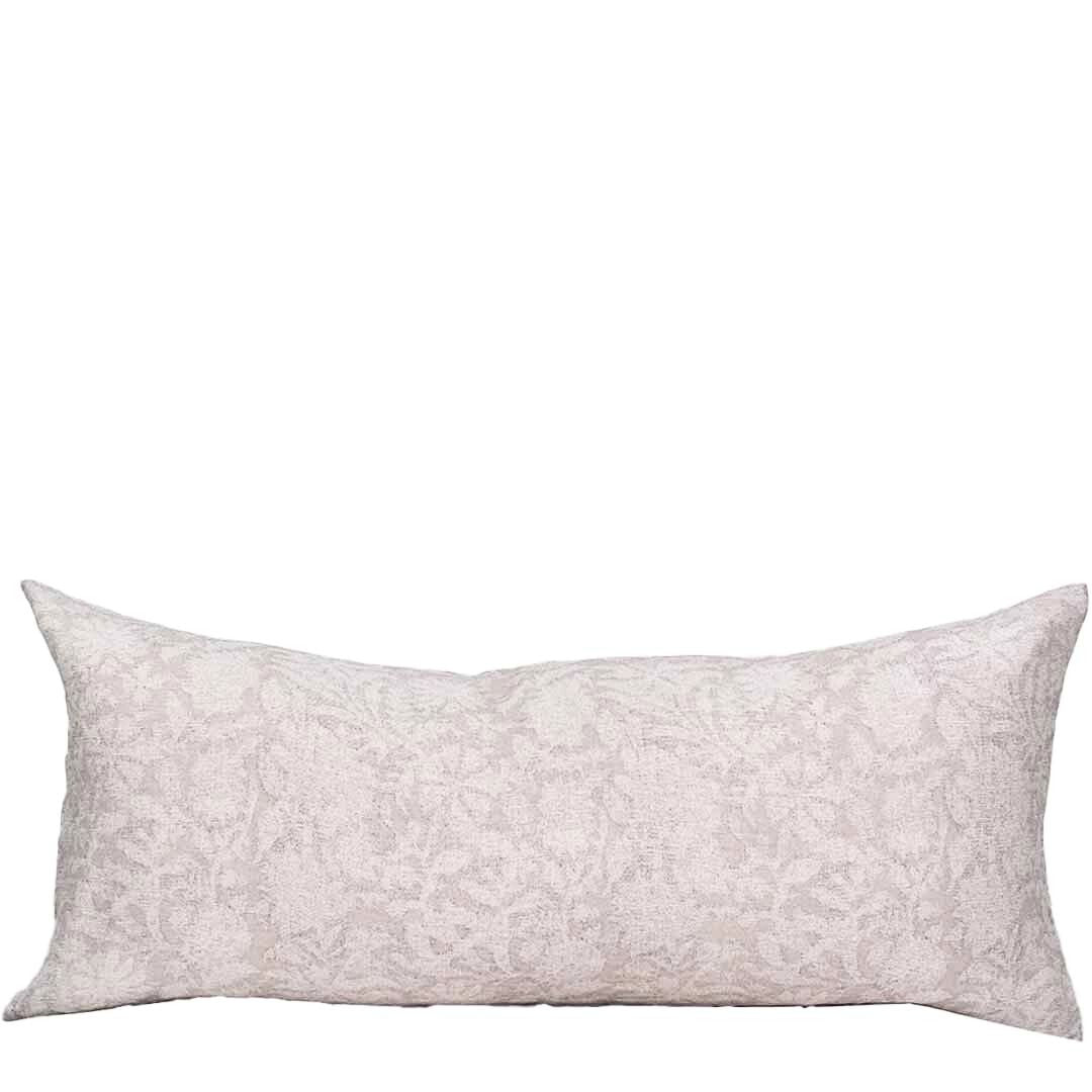 Decorative pillow with a subtle pattern on a white background