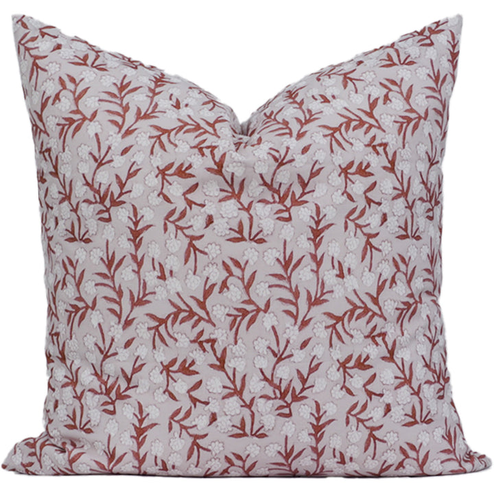 Decorative pillow with red floral pattern on a white background